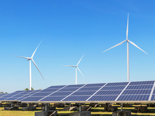 Wall Mural - solar cells or solar panels or photovoltaic cells with wind turbines generating electricity alternat