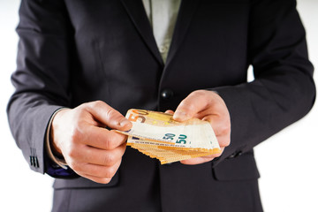 Hands with euros banknote on business background.