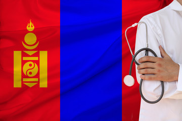 doctor with a stethoscope against the backdrop of the Angola national flag on a beautiful silk fabric, the concept of medical care and insurance