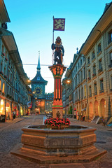 Sticker - Zahringen fountain and Zytglogge clock tower in Kramgasse Bern evening