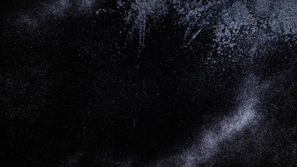 Real frost on a window. Frostwork pattern ice crystals on black background. Dark surface with abstract ice structure makes to overlay or add a frost effect.