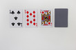 Texas holdem poker flop combination of playoing cards and deck. Five, ten and jack playing cards and deck laying isolated on empty white table background