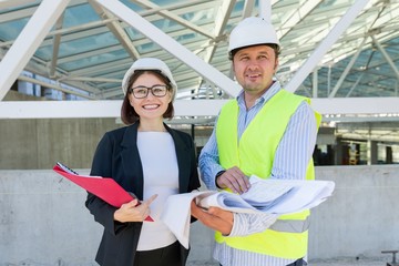 Construction, man and woman builders at construction site