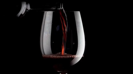 Wall Mural - glass with red wine on black background