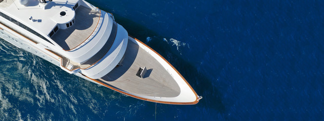 Wall Mural - Aerial drone ultra wide photo of luxury mega yacht with wooden deck anchored in deep blue sea of Mykonos island, Cyclades, Greece