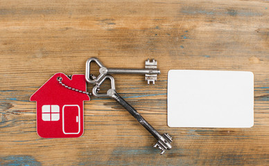 Wall Mural - house key with mockup of credit card on wood table.  Flat lay, top view, copy space