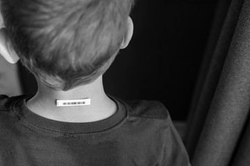 Bar code is on  a child 's neck.  Clone of DNA and human genome. The concept child trafficking, digital concentration camps , electronic cards. Back view.