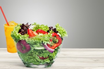 Canvas Print - Fresh tasty vegetable salad in bowl on background