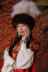 Kazakh national wedding dress. Ornaments and embroidery on fabric. Red dress. Traditional dress of the Kazakh bride.