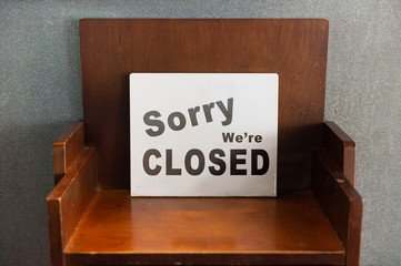 Wall Mural - sorry we are closed sign hanging outside a restaurant, store, office or other