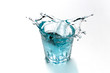 Blue water splashing in transparent glass. Refreshing drink. Drops flying.
