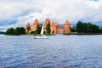 Canvas Print - People in Sailboats on Galve lake Trakai island castle