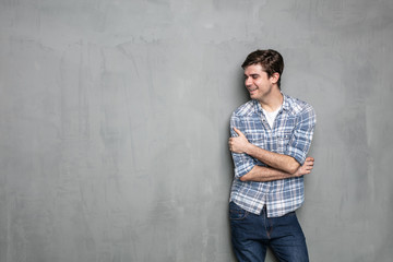 young man standing on a concrete wall