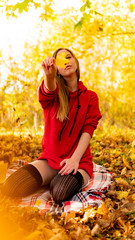 Wall Mural - Incredible stunning girl in a red dress. The background is fantastic autumn. Artistic photography.