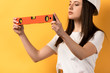 © LIGHTFIELD STUDIOS - cropped view of concentrated handywoman holding spirit level on yellow background