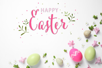 Wall Mural - Flat lay composition with eggs and text Happy Easter on white background
