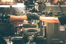 Experienced Entrepreneurs, 2 Engineers Man Used Hand For Fist Bump To Show Their Cooperation For Success Teamwork, With Blur Soft Of Industrial Machinery Background, To People And Synergy Concept.