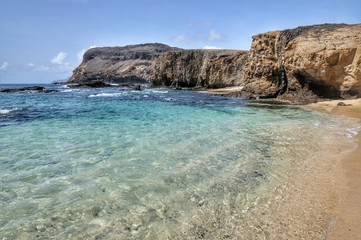 Wall Mural - Clear water by the cliff in Djeu, an islet on the archipelago of Cabo Verde