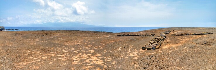 Wall Mural - The dry barren landscape of Djeu on  a plateau with the island of Fogo in view under the clouds