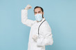 © ViDi Studio - Happy male doctor man in white medical gown sterile face mask gloves isolated on blue background. Epidemic pandemic coronavirus 2019-ncov sars covid-19 flu virus concept. Doing winner gesture say yes.