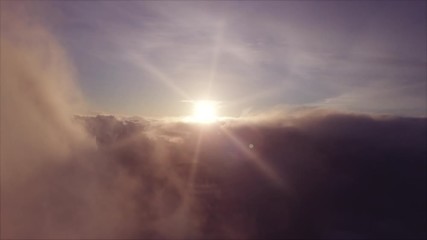 Wall Mural - Seamless Aerial Footage in Clouds at Sunrise - Video Looped
