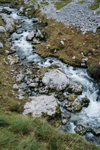 From Above Splashing Mountain River Streaming Through Rocky Mountains In Peaks Of Europe, Asturias, Spain