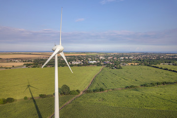 Aerial view of wind turbine generators in field producing clean ecological electricity.