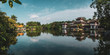 © Kike Arnaiz/ADDICTIVE STOCK - View of calm lake water reflecting sky and oriental buildings on shore with lush tropical greenery, Qingxiu Mountain, China