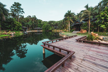 Landscape Of Paved Wooden Pathway Above Calm Water Of Pond In Tropical Park Of Qingxiu Mountain, China