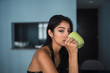 © Kike Arnaiz/ADDICTIVE STOCK - Beautiful passionate brunette Hispanic woman in dress looking at camera and holding mug of hot drink at table with volume in room