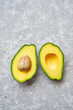 © Peter Karasev/ADDICTIVE STOCK - Top view of fresh ripe avocado cut in half on light grey texture background