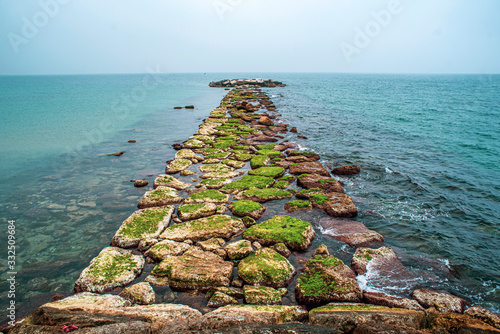 Fotomural Stone jetty at sea. Stone jetty at sea.