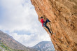 © Javier De La Torre/ADDICTIVE STOCK - From below faceless sportive male alpinist climbing on sheer cliff in summer day