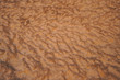 © Juan Alberto Ruiz/ADDICTIVE STOCK - From above abstract relief rough gritty desert brown surface of background texture