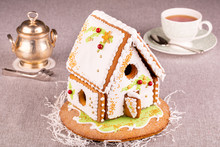 Gingerbread House With Green Patterns And Red Beads