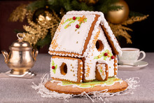 Gingerbreak House With Red Beads And Green Patterns