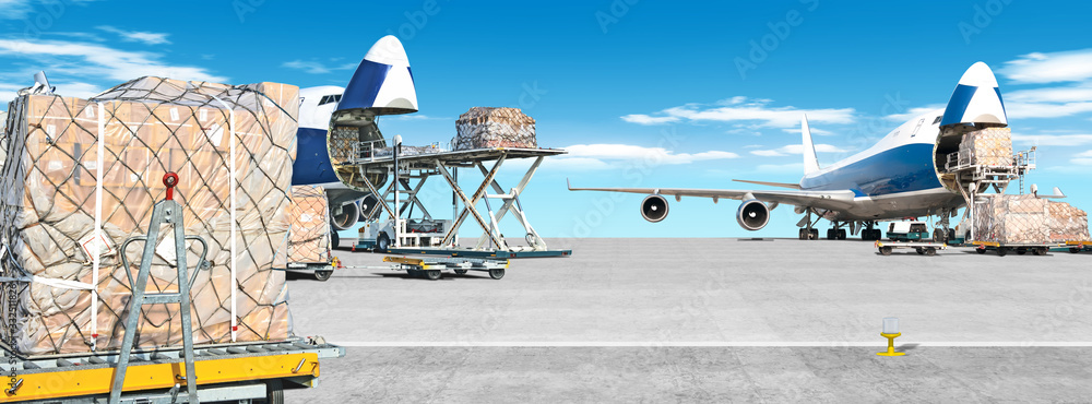 loading cargo airplane on airport runway ultra wide panorama landscape with freight containers and shipping packages on foreground against blue clouds sky background Airport overview with cargo planes - obrazy, fototapety, plakaty 
