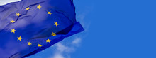 Flag Of The European Union Waving In The Wind On Flagpole Against The Sky With Clouds On Sunny Day, Banner, Close-up
