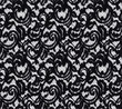 Seamless pattern in the form of an elegant black lace on a white background. Lace with floral motifs.Material for stylish graphic decoration.