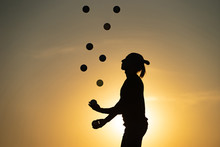 Silhouette Of Juggler With Balls On Colorful Sunset