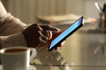 black man hands using mobile phone in the night at home