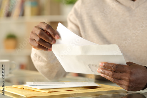 Cuadros en Lienzo Black man hands putting a letter inside an envelope
