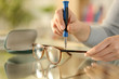 © PheelingsMedia - Woman hands tightening screw on glasses with screwdriver
