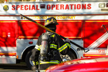Firefighter At Work With Protective Gear At Day