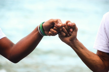 two friends joining their fists as a prove of friendship.
