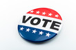© Victor Moussa - Democracy, presidential election and voting poll concept with red, white and blue vote glossy button pin with stars and stripes isolated on white background with clipping path cutout