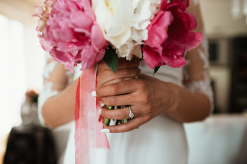  A beautiful bride in a wedding dress with a bouquet in her hand