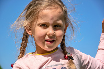 Portrait of a little girl on a blue background