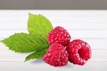 Ripe fresh red raspberries on the desk