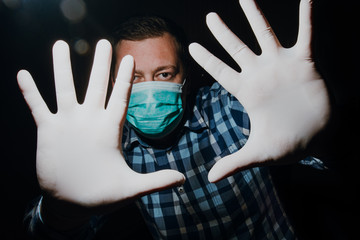 Wall Mural - man hands social distancing with medical gloves and mask for protection from corona virus covid-19